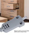 Close-up of Soft Close Damper for Cabinets and Drawers with ABS Plastic Buffer and Adjustable Damping, shown in front of wooden cabinet drawers.