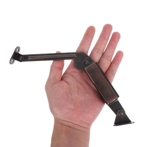 Hand holding 2pcs Soft Close Lid Support Hinges Spring Friction Fold Down Swing Down Hinges for Wooden Boxes Cabinets
