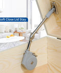 Lid Stay 105 Degree Open with Soft Close installed in a wooden cabinet for toy box lid support.