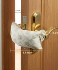 Soft Fabric Door Stopper For Handles With Floral Design Keeps Doors From Slamming And Pinching Fingers Quiet Door Silencer Kid And Pet Safe Farmhouse Style Home Decor shown installed on door handle.