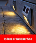 Outdoor lighting fixtures on a stone surface with solar panels, suitable for indoor or outdoor use.