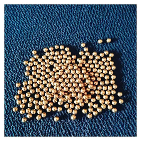 100-Pack 3.175mm Ceramic Balls Solid H62 Brass Ball - Precision Smooth Beads Round Balls displayed on blue fabric