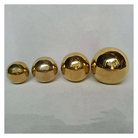 Four solid H62 brass balls of varying sizes displayed on a white background, part of 100-Pack 3.175mm Ceramic Balls Solid H62 Brass Ball.