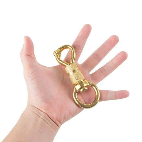 Solid Brass Panic Snap 1-1/8 Inch By 4-1/4 Inch Quick Release With Round Swivel Eye held in hand for size reference