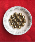 4.76mm 200pcs Solid Pure Copper Balls - Brass Ball Bead displayed in a decorative plate on red fabric