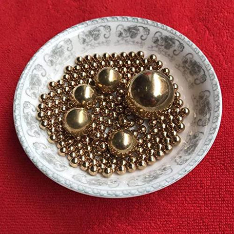 2.381mm 500pcs Solid Pure Copper Balls - Brass Ball Bead displayed on a decorative plate on a red background