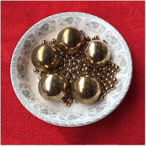 Close-up of 2.381mm 500pcs Solid Pure Copper Balls in a decorative dish on a red background