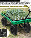 Green garden cart with 12 Inch Flat Free Solid Rubber Tire and Wheel Assembly with 2.1 Inch Offset Hub loaded with plants on grass.