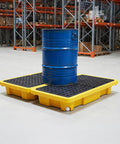 Spill Containment Pallet Set For Two Drums With Drain Outlet, Heavy Duty Plastic Platform Holding Blue Drum In Industrial Warehouse