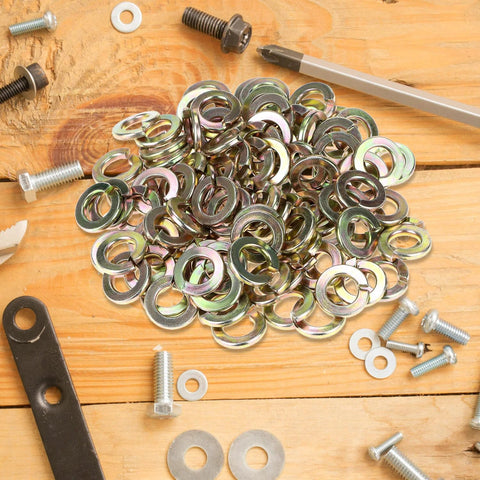 Pile of Split Lock Washer Grade Eight Thru Hardened Steel Yellow Zinc Plated 100 Pack on wooden surface with bolts and tools