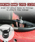 Close-up of 50 Pack 8mm ID Spring Band Clamps installed on a fuel hose in a machinery application, showing secure fit.