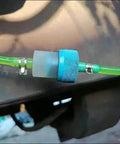 Installed 50 Piece 13mm Half Inch Spring Hose Clamps Kit For Low Pressure Air Lines on green hose, visible connector.