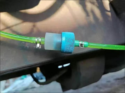 Installed 50 Piece 13mm Half Inch Spring Hose Clamps Kit For Low Pressure Air Lines on green hose, visible connector.