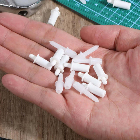 Hand holding 60 Pcs Shutter Repair Pins Shutter Louver Spring Loaded Replacement Pins Repair Plantation Shutters Tool Set