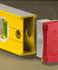 Close-up of Stabila 37424 24 Inch Builders Level with high strength yellow box frame, visible bright vial, and red removable end cap.