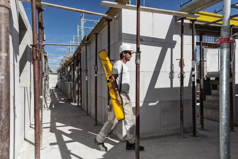 Worker carrying Stabila Jamber Level Case provides secure single-carry transport and organized storage for six level sizes on site.