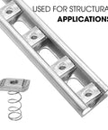 Stainless steel 3/8-16 standard strut channel nuts with a thickened spring installed in a slotted metal channel for structural applications.
