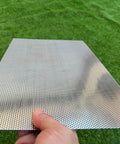 Hand holding Stainless Steel Perforated Sheet 16x10 In, 304 Grade, 19 Gauge With 1/16 Inch Openings, visible metal mesh pattern.