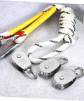 3pcs Heavy Duty Stainless Pulley Swivel Lifting Wire Rope Crane for Construction DIY Projects lying beside rope on concrete surface