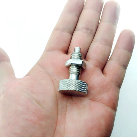Close-up of stainless steel M12x1.75 retractable spring plunger with knurled end knob held in a hand