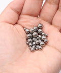 Hand holding stainless steel ball bearings for 600-Pack Utility Cart 8 mm Platform Size Stainless Steel Frame Built for Moving Boxes