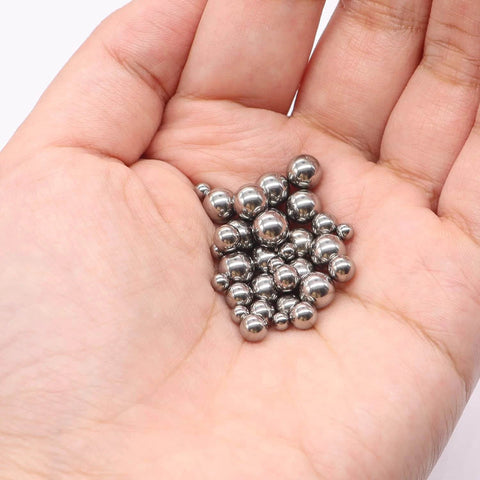 Hand holding stainless steel ball bearings for 600-Pack Utility Cart 8 mm Platform Size Stainless Steel Frame Built for Moving Boxes