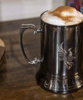 Classic Stainless Steel 20 Ounce Double Wall Beer Stein With Easy Grip Handle Vacuum Insulated Tankard Copper Finish with coffee foam.