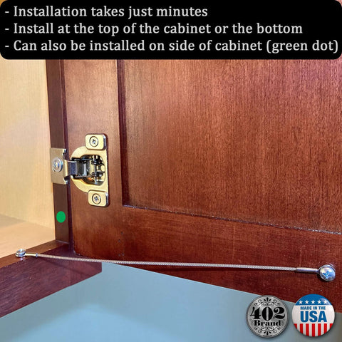 Stainless Steel Cabinet Door Restraint Kit. Made in USA. Flexible braided cable limiting cupboard hinge swing angle, installed view.