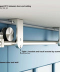 Stainless Steel Ceiling Mount Sliding Barn Door Hardware Kit For Doors One And Three Eighths To One And Three Quarters Inches Thick Supports Up To 198 Lb Includes Two Flat Rollers Two Stoppers Two 3.3 Foot Tracks Track Connector And Four Round Brackets installed on a blue door.
