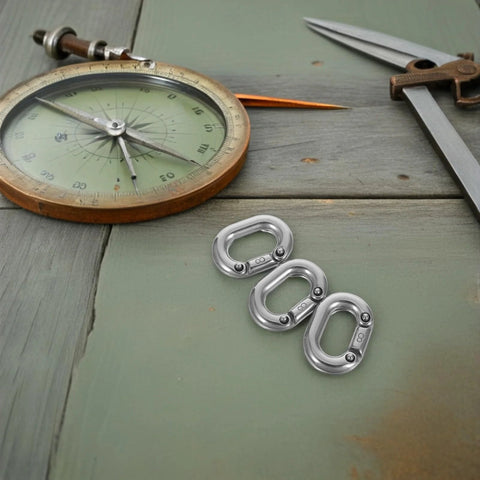 Close-up of three 8mm stainless steel quick-connect chain connectors for rigging and anchor chain repair.