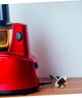Replacement Coupling Pin for Juicer and Blender Parts With Stainless Steel Construction next to a red juicer base on a counter