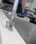 Installed stainless steel quick-release boat deck hatch hinge pin on white boat deck