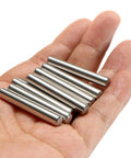 Hand holding 24 Piece Dowel Pins 6 Mm By 40 Mm 304 Stainless Steel Pegs For Shelves And Furniture Support, silver tone, cylindrical pins
