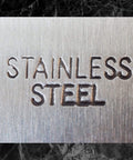 Close-up of the text 'Stainless Steel' engraved on a metal surface for Three Sixteenth Inch 440 Stainless Steel Bearing Balls Grade G25.