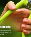 Close-up of a hand gripping the green handle of a pruning shear from the 2 Pack Stainless Steel Gardening Scissors Set With Pruning Shears And Clippers For Garden Pruning Versatile Dual Cut Pruning Combo For Delicate Flower And Shrub Trim To Thick Branches Vegetables Fruits And Landscaping.