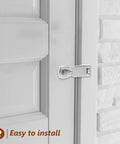 Installed marine-grade stainless steel gate latch on white exterior door