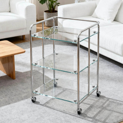 Glass shelf cart with chrome frame and wheels in modern living room setting.