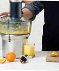 Person using juicer with Stainless Steel Juicer Coupling Replacement Plug And Play Drive Connector No Fuss For Various Juicer Models.