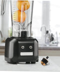 Stainless Steel Juicer Coupling Replacement Plug And Play Drive Connector next to black blender on kitchen counter
