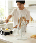 Man cooking with Kitchen Utensil Hanger Stainless Steel Utensil holder Rotatable Cooking Utensils Holder with 8 Hooks in a kitchen