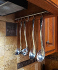 Kitchen Utensil Rack 2 Pack, 15.6 Inch Pots and Pans Hanging Rack Wall Mounted with utensils in a kitchen setting