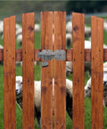 Flip Gate Latch With Padlock Hole Heavy Duty Stainless Steel Door Latch on wooden fence with sheep visible