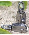 Stainless Steel Pulley M15 Single Wheel Swivel Lifting Rope Pulley Set displayed on sand, showing metal components.