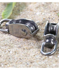 M20 Cable Single Pulley Block Stainless Steel on sandy surface for marine towing and lifting applications