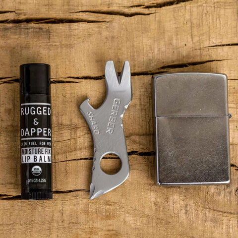 Shard 7 in 1 Keychain Multitool with bottle opener and screwdriver, lightweight stainless steel, shown with lip balm and lighter.