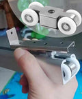 Hand holding Stainless Steel Heavy Duty Sliding Patio Door Rollers With Ball Bearing Wheel Pulley for Wood Aluminum Vinyl Doors