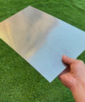 Person holding Stainless Steel Perforated Sheet 16x10 In, 304 Grade, 19 Gauge With 1/16 Inch Openings on grass
