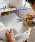 Person cutting Durable 304 Stainless Steel Perforated Sheet with 0.06 inch holes and 0.02 inch thickness measures 9.5 inches wide.