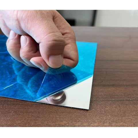 Peeling protective film off 430 Stainless Steel Magnetic Mounting Plates 12 x 6 Inches 0.5mm Thick Mirror Finish for Kitchens and Offices