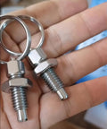 Close-up of two Beefy Heavy Duty Stainless Steel Pull Ring Indexing Plungers in hand, showcasing M10 threads and durable design.